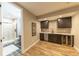This lovely finished basement wet bar includes a dishwasher, wine fridge, and adjacent bathroom at 6759 Canyonpoint Rd, Castle Pines, CO 80108