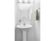 Clean bathroom featuring a pedestal sink, a large mirror, and contemporary fixtures at 8787 Yukon St, Arvada, CO 80005