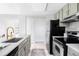 Modern kitchen with stainless steel appliances, stylish cabinets, and a sleek countertop at 8787 Yukon St, Arvada, CO 80005
