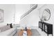 Stylish living room showcases a staircase, modern furnishings, and a decorative mirror at 8787 Yukon St, Arvada, CO 80005