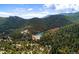 A lake surrounded by trees and mountains creates a picturesque landscape for the homes below at 1608 Beaver Brook Canyon Rd, Evergreen, CO 80439