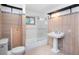 Updated bathroom with wood-look tile, glass shower door, large sink, and black decorative shelf at 1608 Beaver Brook Canyon Rd, Evergreen, CO 80439