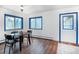 Bright dining room featuring wood floors, natural light, and blue trimmed windows and door at 1608 Beaver Brook Canyon Rd, Evergreen, CO 80439