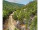 Charming two-story home tucked away in a serene, wooded area with a winding dirt road at 1608 Beaver Brook Canyon Rd, Evergreen, CO 80439