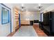 Charming kitchen with wood floors, blue-framed doors, patterned tile backsplash, wood cabinets, and black appliances at 1608 Beaver Brook Canyon Rd, Evergreen, CO 80439