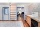 Kitchen with wood floors, blue-framed doors, patterned tile backsplash, wood cabinets, and open access to the living room at 1608 Beaver Brook Canyon Rd, Evergreen, CO 80439