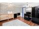 Rustic kitchen with wood floors, blue-framed doors, patterned tile backsplash, farm sink, and black appliances at 1608 Beaver Brook Canyon Rd, Evergreen, CO 80439