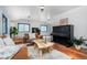 Bright living room with hardwood floors, leather sofas, and large windows with blue trim at 1608 Beaver Brook Canyon Rd, Evergreen, CO 80439