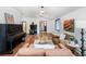Inviting living room featuring hardwood floors, wood burning stove, vintage piano, and comfortable seating at 1608 Beaver Brook Canyon Rd, Evergreen, CO 80439