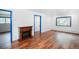 Open living room area with laminate wood floors, a charming electric fireplace, and natural light at 1608 Beaver Brook Canyon Rd, Evergreen, CO 80439