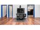 Living room featuring an antique stove with hardwood floors and open doorways at 1608 Beaver Brook Canyon Rd, Evergreen, CO 80439