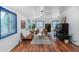 Inviting living room with hardwood floors, leather sofas, and blue-trimmed windows at 1608 Beaver Brook Canyon Rd, Evergreen, CO 80439