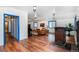 Spacious living room showcasing wood floors, wood burning stove, ample natural light, and comfortable seating at 1608 Beaver Brook Canyon Rd, Evergreen, CO 80439