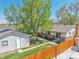 Aerial view of backyard featuring lush landscaping, a white detached garage and a patio at 4781 S Grant St, Englewood, CO 80113