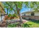 Outdoor patio space with bench, trees, and grass - perfect for relaxing outside at 4781 S Grant St, Englewood, CO 80113