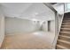 Unfinished basement with carpet flooring, a staircase, and bright recessed lighting at 4781 S Grant St, Englewood, CO 80113
