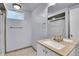 Well-lit bathroom featuring vanity, shower, towel rack, and light tan tile flooring at 4781 S Grant St, Englewood, CO 80113