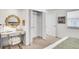 A bedroom featuring a desk area, walk-in closet, and neutral carpet flooring at 4781 S Grant St, Englewood, CO 80113