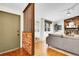 Living room featuring hardwood floors, a brick fireplace, and an adjacent front entry with tile floors at 4781 S Grant St, Englewood, CO 80113