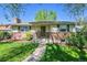 Charming one-story home with brick accents and well-manicured front lawn and landscape at 4781 S Grant St, Englewood, CO 80113