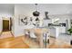 Bright eat-in kitchen with stainless hood, white cabinets, floating shelves, and sleek, modern finishes at 4781 S Grant St, Englewood, CO 80113