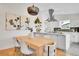 Bright eat-in kitchen with stainless hood, white cabinets, floating shelves, and sleek, modern finishes at 4781 S Grant St, Englewood, CO 80113