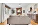 Bright living room featuring hardwood floors, a fireplace, comfortable seating, and tasteful decor at 4781 S Grant St, Englewood, CO 80113