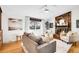 Bright living room featuring hardwood floors, a fireplace, comfortable seating, and tasteful decor at 4781 S Grant St, Englewood, CO 80113