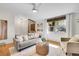Bright living room with hardwood floors, large window, and comfortable furnishings creating an inviting space at 4781 S Grant St, Englewood, CO 80113
