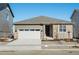 Modern ranch style home with neutral exterior, attached garage, and small front yard at 1927 S Coolidge Way, Aurora, CO 80018