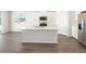 Kitchen island with white quartz countertop and breakfast bar at 1927 S Coolidge Way, Aurora, CO 80018