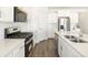 Modern kitchen featuring stainless steel appliances and white cabinetry at 1927 S Coolidge Way, Aurora, CO 80018