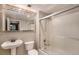 Clean bathroom with a tub, shower, and updated vanity at 830 N Sherman St # 106, Denver, CO 80203