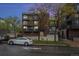 Brick apartment building with balconies and ample parking at 830 N Sherman St # 106, Denver, CO 80203