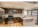 Modern kitchen with stainless steel appliances and dark wood cabinets at 830 N Sherman St # 106, Denver, CO 80203