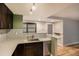 Modern kitchen with dark cabinetry, stainless steel appliances, and quartz countertops at 830 N Sherman St # 106, Denver, CO 80203