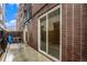 Private patio with brick wall and bistro table at 830 N Sherman St # 106, Denver, CO 80203