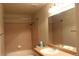 Bathroom featuring a shower and tub combination, and vanity with a mirror at 8603 E Dry Creek Rd # 211, Englewood, CO 80112