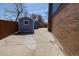 View of backyard showing a shed and brick siding of house at 6720 W 112Th Pl, Westminster, CO 80020