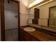 Bathroom featuring a single sink vanity, towel racks, and walk-in shower at 6720 W 112Th Pl, Westminster, CO 80020