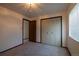 A bedroom with a window, carpeting, and a closet at 6720 W 112Th Pl, Westminster, CO 80020