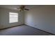A bedroom featuring neutral carpeting, a ceiling fan, and a window at 6720 W 112Th Pl, Westminster, CO 80020