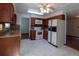 A full kitchen featuring wood cabinetry, laminate countertops, and white appliances at 6720 W 112Th Pl, Westminster, CO 80020