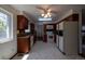 Traditional kitchen featuring wooden cabinets, white appliances, and a window with natural light at 6720 W 112Th Pl, Westminster, CO 80020