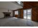 Open floorplan of the living room with a brick fireplace and sliding glass doors at 6720 W 112Th Pl, Westminster, CO 80020
