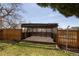 Backyard with covered wooden pergola and wooden fence at 6720 W 112Th Pl, Westminster, CO 80020