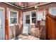 Brick exterior featuring a white door, window, utility box, and wooden fence at 2813 Jasmine St, Denver, CO 80207