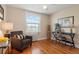 Cozy bedroom featuring hardwood floors, a comfortable chair, and a functional work space at 2813 Jasmine St, Denver, CO 80207