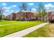 Brick townhouses with green lawns offer a serene setting and community feel at 2813 Jasmine St, Denver, CO 80207