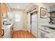 Bright kitchen featuring modern countertops, stainless steel appliances, and convenient sliding door closet at 2813 Jasmine St, Denver, CO 80207